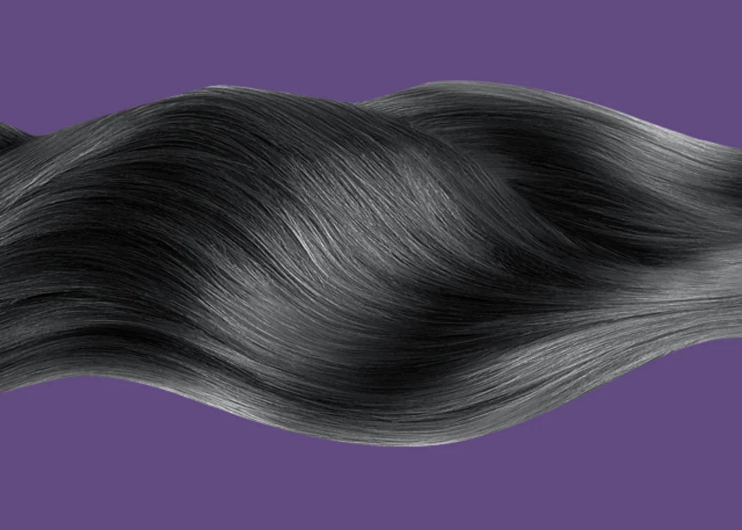 black hair extensions flow across a purple background.