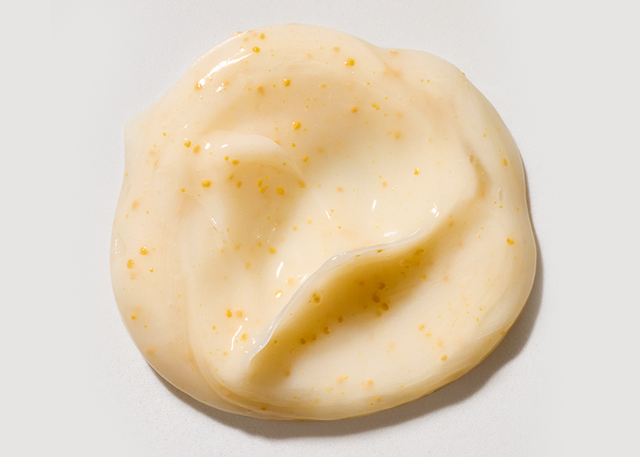 Swirl of protein treatment product dispensed on a white background.