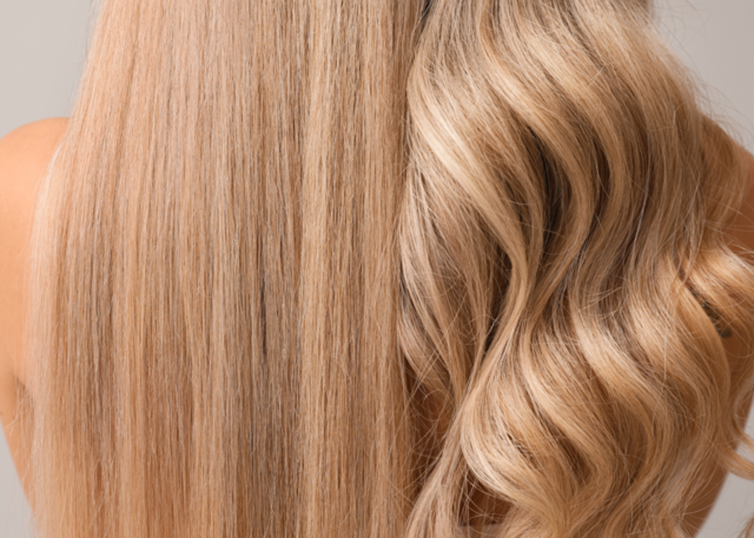 Women with fair skin and blonde hair has the left half of hair straight and the right half of hair wavy in front of a grey background