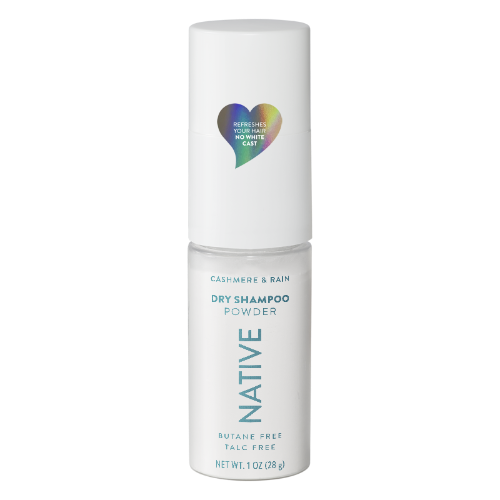 Native Cashmere & Rain Dry Shampoo Powder in a white cylindrical bottle with a matching cap, featuring a colorful heart-shaped logo and blue text on a white background.